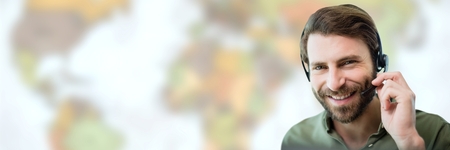 Digital composite of Travel agent man wearing headset in front of world map