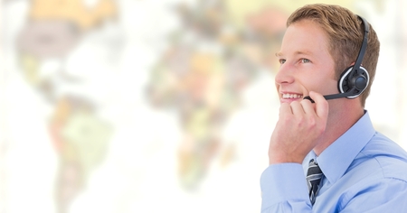 Digital composite of Travel agent man wearing headset in front of world map