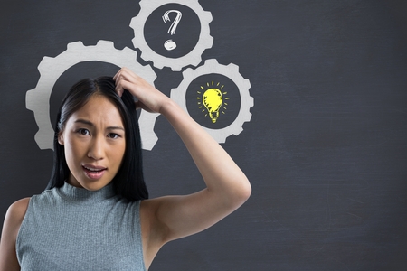Digital composite of Confused woman scratching her head with cogs and drawings