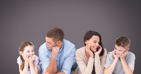 Digital composite of Family laughing together with grey backgroundの写真素材