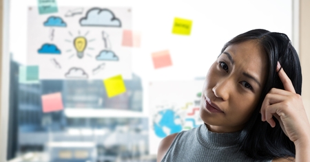 Digital composite of Woman scratching her head and drawingsの写真素材