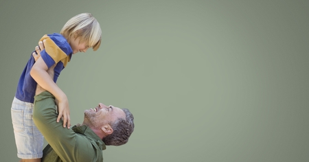 Digital composite of Father and son laughing with green backgroundの写真素材