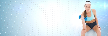 Digital composite of Fit athletic woman with blue background and exercise ballの写真素材