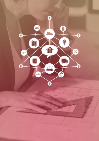 Digital composite of Business woman examining a plan with graph overlaysの写真素材