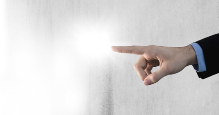 Digital composite of hand pointing with grey backgroundの写真素材