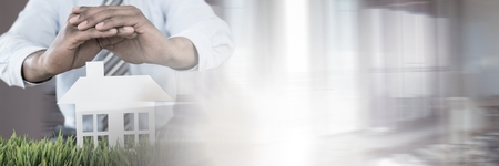 Digital composite of Paper Cut Out house with businessmanの写真素材