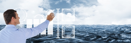 Digital composite of Man touching interface with sea backgroundの写真素材