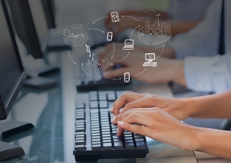 Digital composite of Hands writing on computer with graph overlays