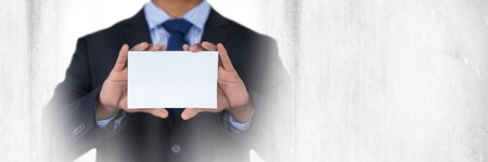 Digital composite of Blank card in businessman's handsの写真素材