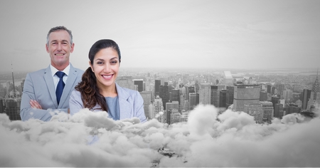 Digital composite of Business man and woman facing out with city skyline behind them and clouds in frontの写真素材