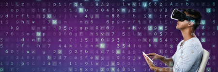 Man using virtual reality headset and digital tablet against purple and pink backgroundの写真素材