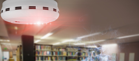 Smoke and fire detector against computer desks in the libraryの写真素材