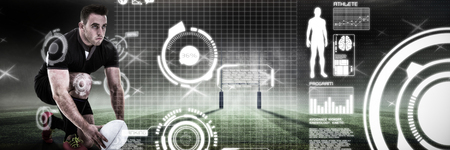 Rugby player positioning ball against rugby pitchの写真素材