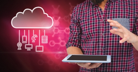 Digital composite of Hand holding tablet with cloud icon and hanging connection devices