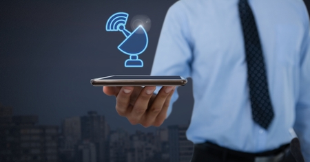 Digital composite of Hand holding tablet with wifi signal iconの写真素材