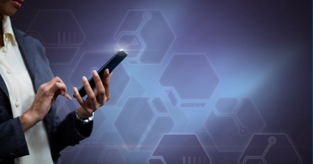 Digital composite of Hand holding phone with technological background
