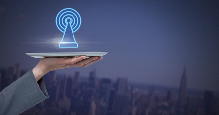 Digital composite of Hand holding tablet with signal icon