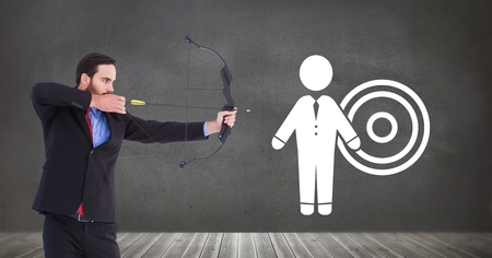 Digital composite of Businessman shooting arrow at target iconの写真素材