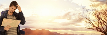 Digital composite of Travelling man with map in front of landscape