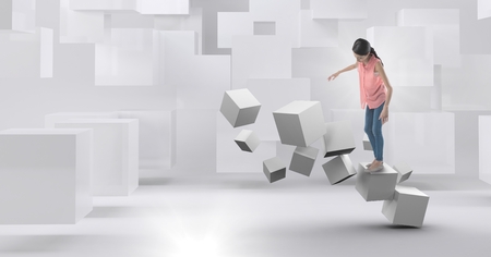Digital composite of Woman balancing on geometric surreal cubesの写真素材