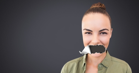 Digital composite of Woman with torn paper on mouthの写真素材