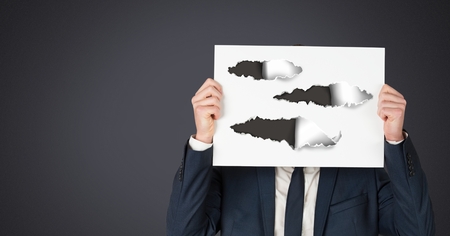 Digital composite of Businessman holding card with torn paperの写真素材