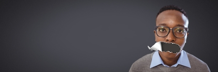 Digital composite of Young man with torn paper on mouthの写真素材