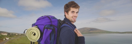 Digital composite of Travelling man with bag in front of landscape