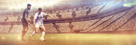 Football Duel  against view of a stadiumの写真素材