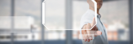 Man pretending to touch an invisible screen against white background against buildings and mountain seen through glass in officeの写真素材