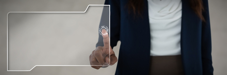 Mid section of businesswoman gesturing against gray cracked concrete wallの写真素材