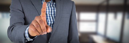 Focused businessman pointing against table and empty chairs in officeの写真素材