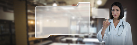 Female doctor touching invisible screen against tables in office cafeteriaの写真素材