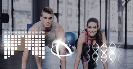 Digital composite of athletic fit couple in gym with health interfaceの写真素材