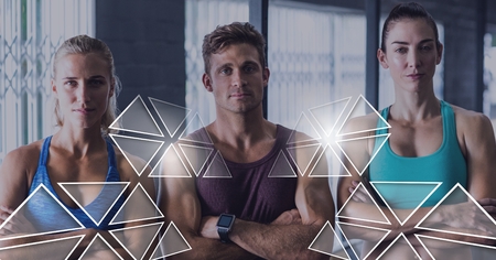Digital composite of athletic fit group of people in gym with triangle interfaceの写真素材