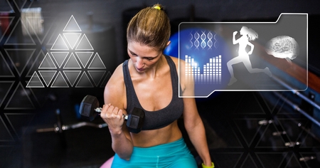 Digital composite of athletic fit woman in gym with health interfaceの写真素材