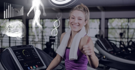 Digital composite of sthletic fit woman in gym with health interfaceの写真素材