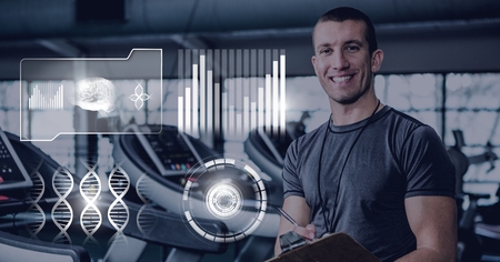 Digital composite of athletic fit trainer man in gym with health interfaceの写真素材