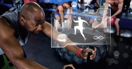 Digital composite of athletic fit man in gym with health interfaceの写真素材