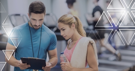 Digital composite of athletic fit trainer people in gym with triangle interface
