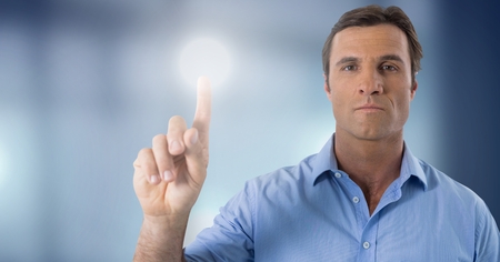 Digital composite of Businessman touching air glow circle