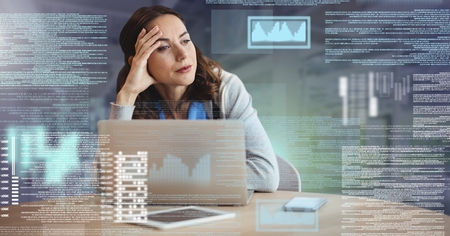 Digital composite of Businesswoman working on laptop with screen text interface