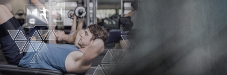 Digital composite of Athletic fit man in gym with health interface