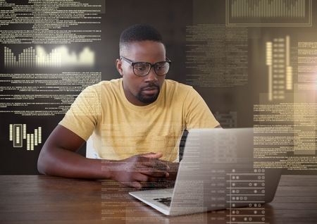 Digital composite of Businessman working on laptop with screen text interfaceの写真素材