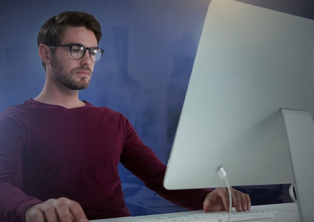 Digital composite of Businessman working on laptop with purple backgroundの写真素材