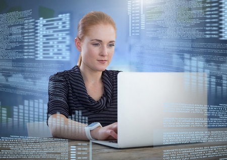 Digital composite of Businesswoman working on laptop with screen text interface
