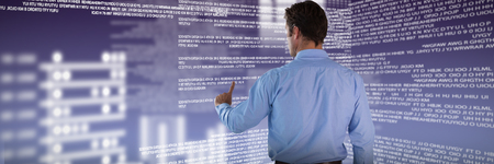 Businessman in blue shirt using invisible interface against gray and purple backgroundの写真素材