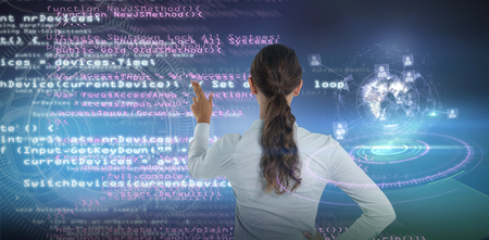 Female executive pressing an invisible virtual screen against digital interface of volume dial interfaceの写真素材