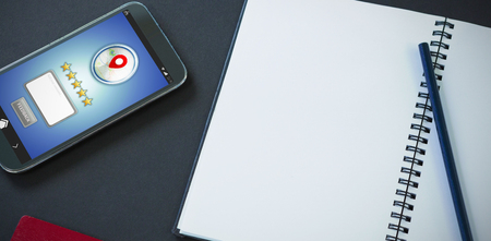 GPS against passport, mobile phone, pencil and organizer on black backgroundの写真素材