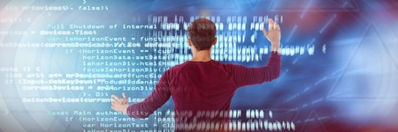 Businessman using invisible interface against blue codeの写真素材